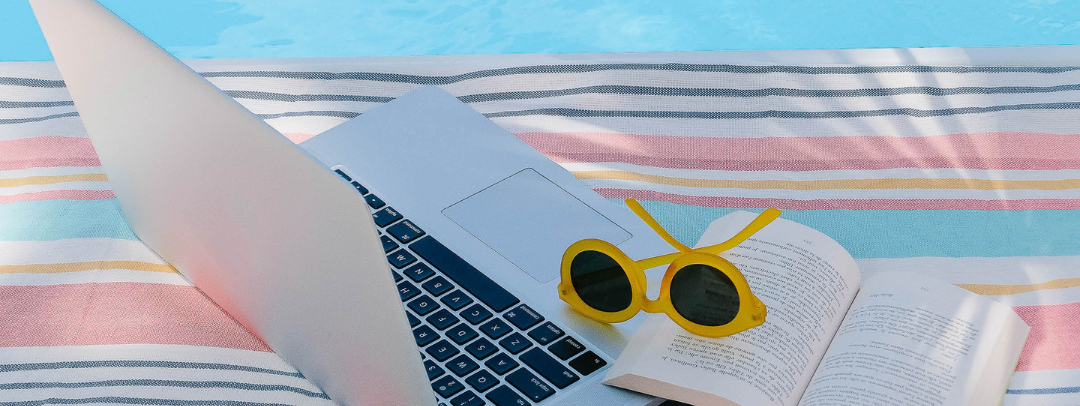 LAPTOP AND BOOK POOLSIDE